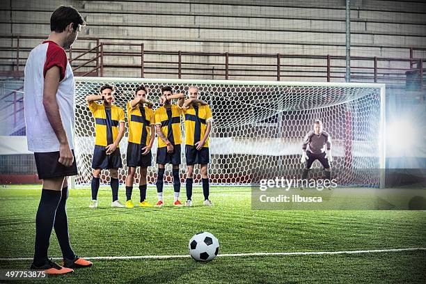 football match in stadium: free kick - kicking soccer stock pictures, royalty-free photos & images