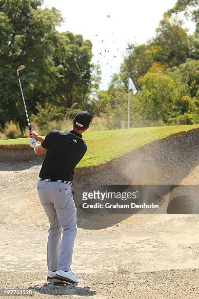 Adam Scott of Australia hits a shot from the bunker during day one of the 2015 Australian Masters at Huntingdale Golf Course on November 19, 2015 in...