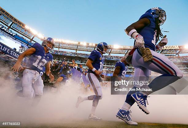 Ryan Nassib, Eli Manning and Dwayne Harris of the New York Giants take the field for a game against the New England Patriots on November 15, 2015 at...