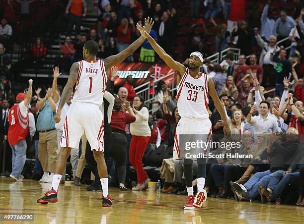 Trevor Ariza and Corey Brewer of the Houston Rockets celebrate after Brewer hit a three-point shot near the end of the fourth quarter against the...