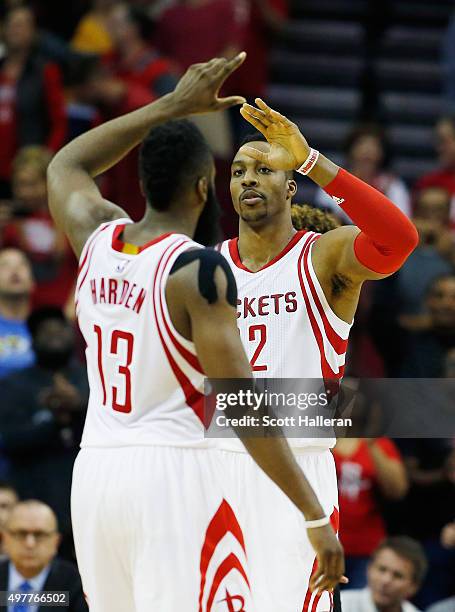 James Harden and Dwight Howard the Houston Rockets celebrates a play near the end of the fourth quarter against the Portland Trail Blazers during...