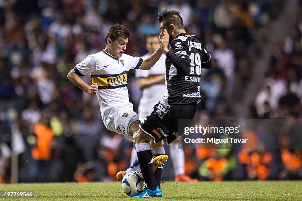 Flavio Santos of Puebla struggles for the ball with Adrian Cubas of Boca Juniors during the opening friendly match between Puebla and Boca Juniors at...