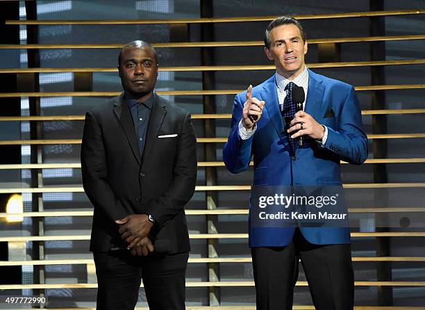 Former NFL players Marshall Faulk and Kurt Warner speak onstage at A+E Networks "Shining A Light" concert at The Shrine Auditorium on November 18,...