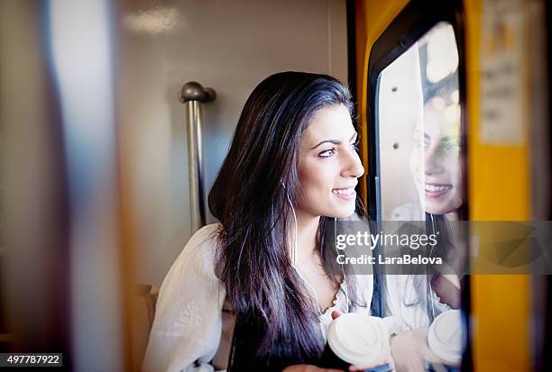 junge frau, die ein fenster im u-bahnzug - sydney trains stock-fotos und bilder