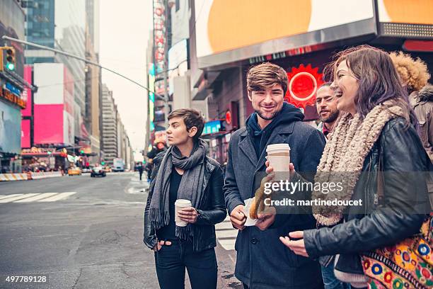 group of people waiting at street corner in new york. - couple crossing street stock pictures, royalty-free photos & images