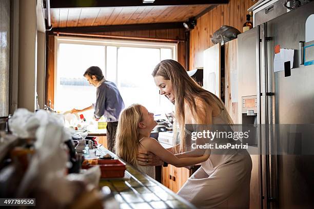 family at home preparing for a celebration event on sunday - young family stock pictures, royalty-free photos & images