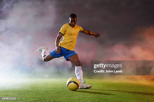 shooting power - soccer player stock pictures, royalty-free photos & images