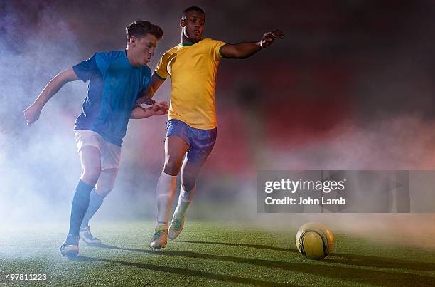 match action - two guys playing soccer stockfoto's en -beelden