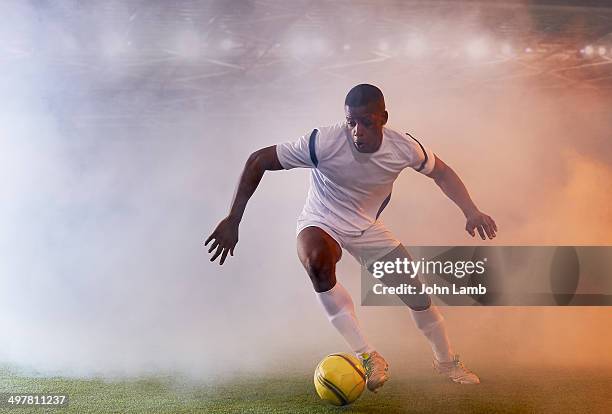 playing through the smoke - dribbling sport fotografías e imágenes de stock