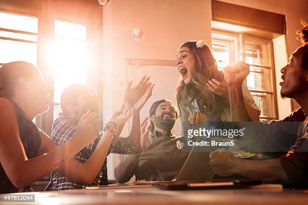 excited business team celebrating their success at office. - office excitement stock pictures, royalty-free photos & images