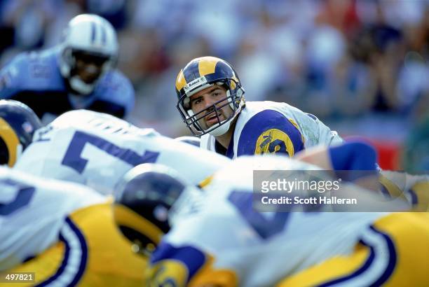 Kurt Warner of the St. Louis Rams looks down the line of scrimmage during the game against the Nasahville Titans at the Adelphia Coliseum in...