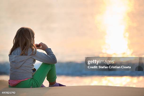 admiring the sunrise at black sea - mamaia romania stock pictures, royalty-free photos & images