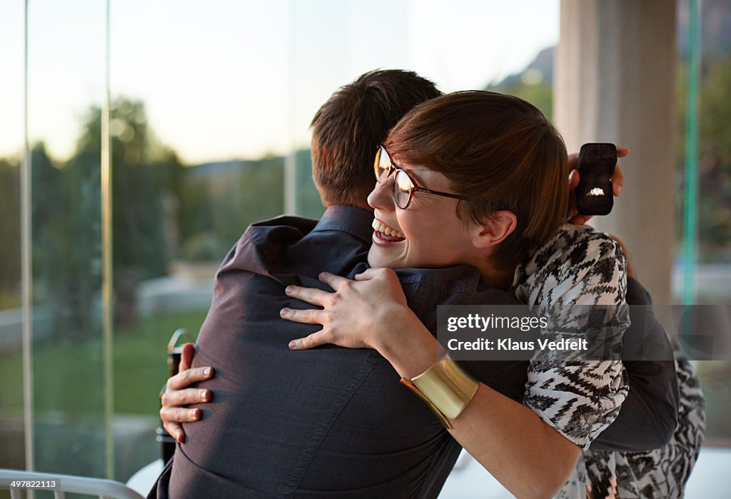 Girlfriend hugging boyfriend after getting ring