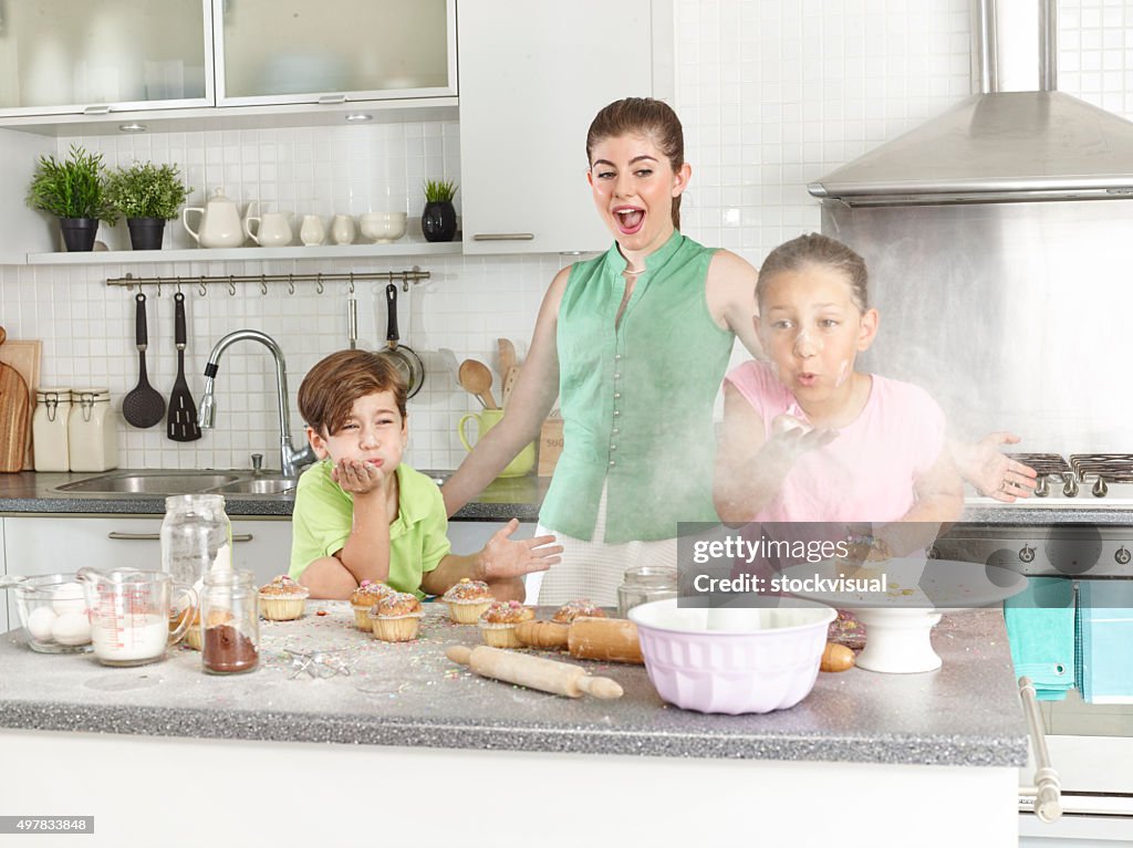 Family Preparing Cupcake In Kitchen