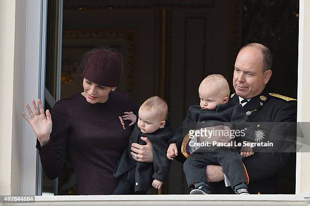 Princess Charlene of Monaco with Princess Gabriela and Prince Albert II of Monaco with Prince Jacques greet the crowd from the palace's balcony...