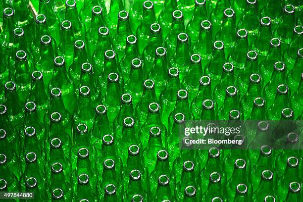 Empty bottles for Heineken beer move along the production line at the Heineken NV brewery in Saint Petersburg, Russia, on Wednesday, Nov. 18, 2015....