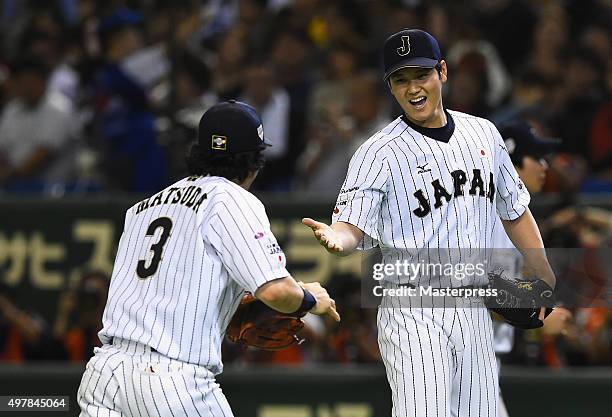 Starting pitcher Shohei Otani of Japan high fives with infielder Nobuhiro Matsuda after the top of sixth inning during the WBSC Premier 12 semi final...