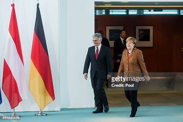 Austrian Chancellor Werner Faymann and German Chancellor Angela Merkel prepare to give a joint press conference at the German Chancellery on November...