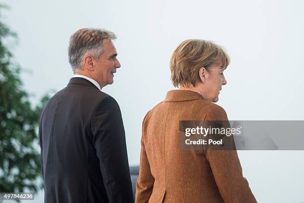 Austrian Chancellor Werner Faymann and German Chancellor Angela Merkel attend a joint press conference at the German Chancellery on November 19, 2015...