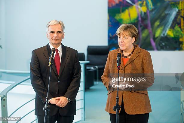 Austrian Chancellor Werner Faymann and German Chancellor Angela Merkel give a joint press conference at the German Chancellery on November 19, 2015...