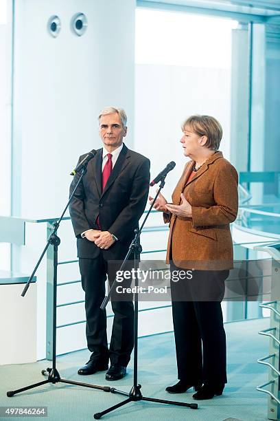 Austrian Chancellor Werner Faymann and German Chancellor Angela Merkel give a joint press conference at the German Chancellery on November 19, 2015...