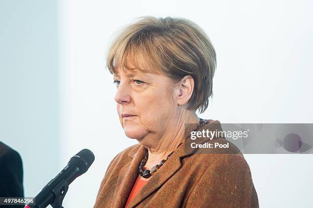 Austrian Chancellor Werner Faymann and German Chancellor Angela Merkel give a joint press conference at the German Chancellery on November 19, 2015...