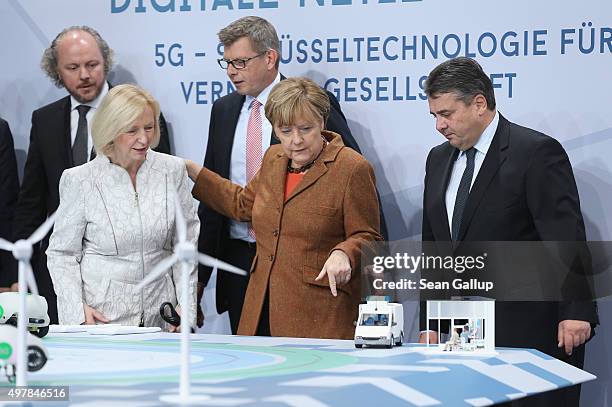 German Chancellor Angela Merkel , Vice Chancellor and Economy and Energy Minister Sigmar Gabriel and Education Minister Johanna Wanka look at a...