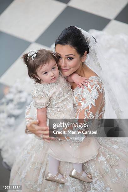 Jenni "JWoww" Farley and her daughter Meilani pose for wedding photographs at their wedding at Addison Park on October 18, 2015 in Keyport, New...