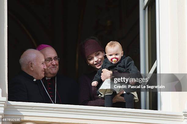 Princess Charlene of Monaco attends a balcony apprearance during the National day celebrations with Princess Gabriella as Archbishop Barsi and Father...