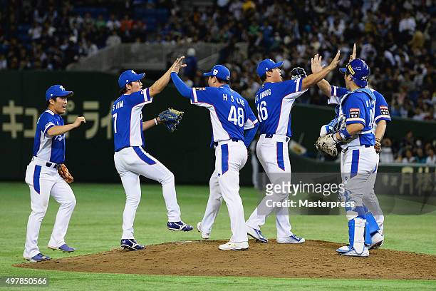 South Korean players celebrate their 4-3 win in the WBSC Premier 12 semi final match between South Korea and Japan at the Tokyo Dome on November 19,...