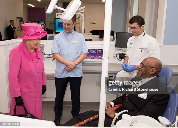 Queen Elizabeth II meets patient Gerald Brown in a dental chair used to train dentists during a tour of the new Birmingham Hospital and School of...