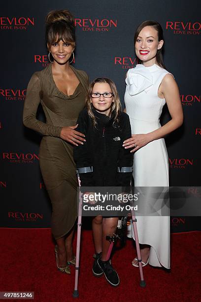Revlon Global Brand Ambassador Halle Berry, Perry Zimmerman, and Revlon Global Brand Ambassador Olivia Wilde celebrate the Revlon LOVE IS ON Million...