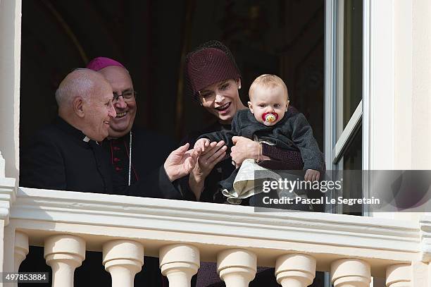 Princess Charlene of Monaco attends a balcony apprearance during the National day celebrations with Princess Gabriella as Archbishop Barsi and Father...
