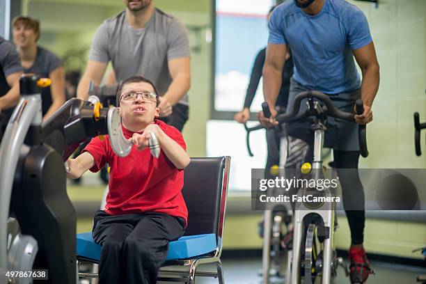 handicap man in a fitness class - genetic disorder stock pictures, royalty-free photos & images