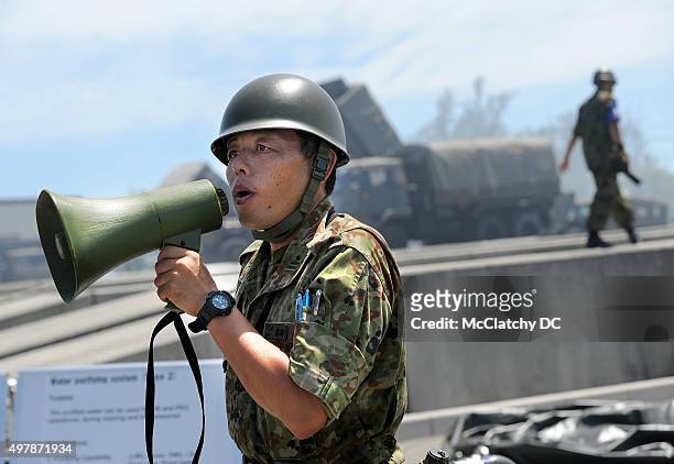 Japanese soldier explains a water filtration center during a joint exercise between the U.S. Marines and the Japanese Ground Self-Defense Force in...