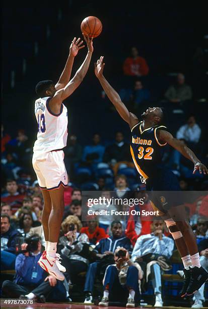 Pervis Ellison of the Washington Bullets shoots over Dale Davis of the Indiana Pacers during an NBA basketball game circa 1992 at the Capital Centre...