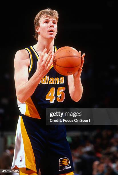 Rik Smits of the Indian Pacers looks to shoot a free throw against the Washington Bullets during an NBA basketball game circa 1995 at US Airways...