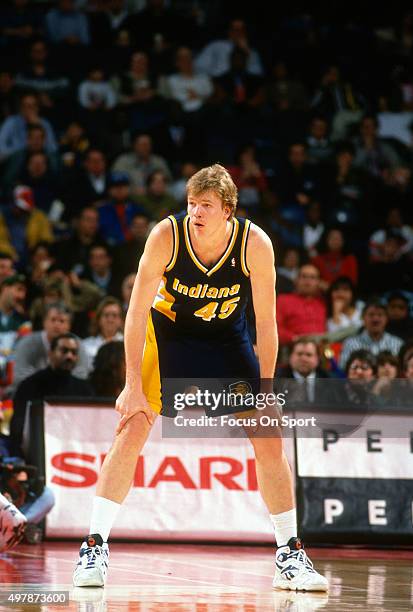 Rik Smits of the Indian Pacers looks on against the Washington Bullets during an NBA basketball game circa 1995 at US Airways Arena in Landover,...