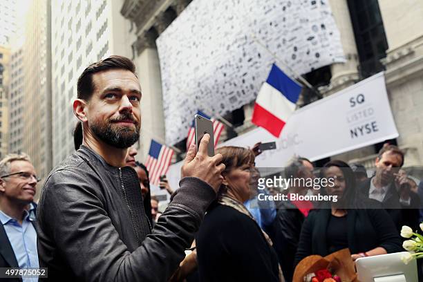 Jack Dorsey, chief executive officer of Square Inc., holds an Apple Inc. IPhone while standing outside of the New York Stock Exchange in New York,...