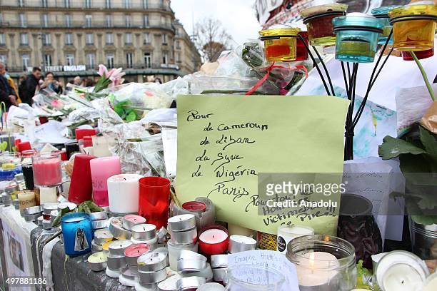 Flowers, candles and messages are seen at a makeshift memorial for the victims of the Paris terror attacks at Place de la Republique in Paris, France...