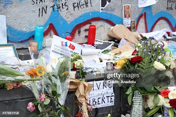 Flowers, candles and messages are seen at a makeshift memorial for the victims of the Paris terror attacks at Place de la Republique in Paris, France...