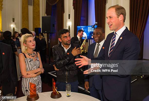 Prince William, Duke of Cambridge and Centrepoint Chief Executive Seyi Obakin talk to award winners Rebecca Stephenson and Ezat Gulzaman at the HSBC...