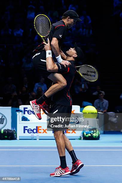 Mike Bryan of the USA and Bob Bryan of the USA celebrate their victory in their men's doubles match against Jamie Murray of Great Britain and John...