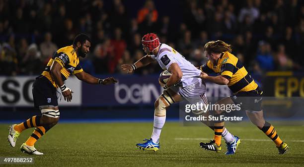 Harlequins player Sam Twomey is tackled by Manoa Vosawai and Kristian Dacey of the Blues during the European Rugby Challenge Cup match between...