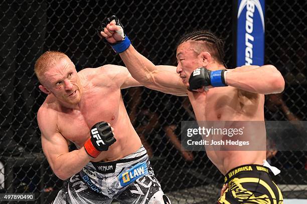 Tatsuya Kawajiri punches Dennis Siver in their featherweight bout during the UFC Fight Night event at the O2 World on June 20, 2015 in Berlin,...