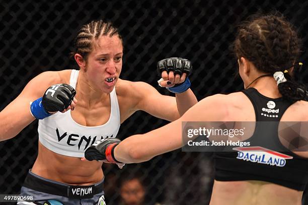 Jessica Penne punches Joanna Jedrzejczyk in their women's strawweight championship bout during the UFC Fight Night event at the O2 World on June 20,...