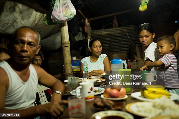 Arabelle Ibanez eats dinner with her family in their home that was destroyed by Typhoon Haiyan in Dulag, Philippines on April 26, 2014. Arabelle is a...