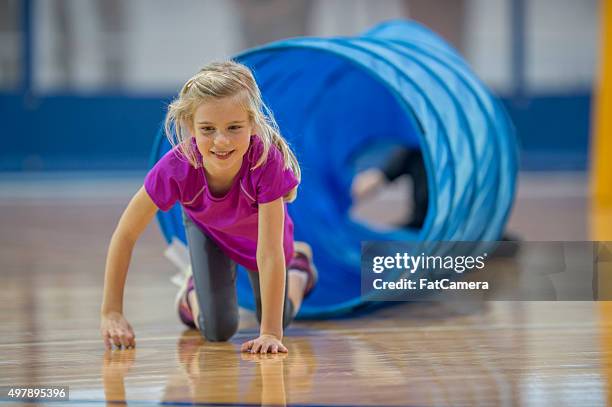 crawling out of a tunnel - little kids doing gymnastics stock pictures, royalty-free photos & images