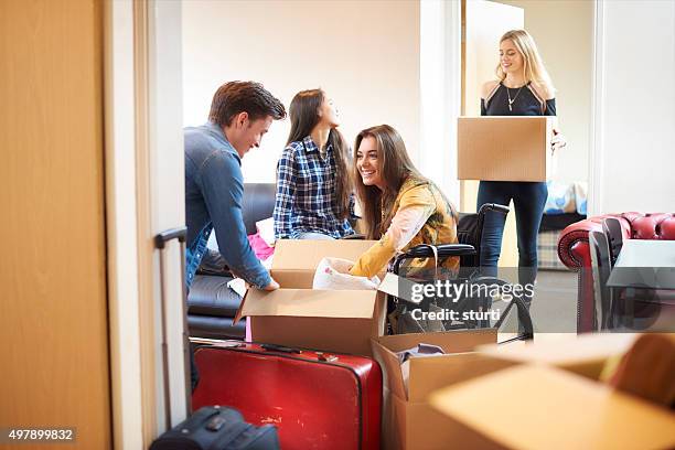 student with disability and housemates moving into halls - college apartment stock pictures, royalty-free photos & images