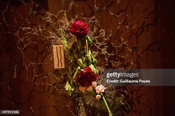 Flowers, inside bullet hole through the glass of the "Le Carillon" restaurant in the 11th district of Paris, following a series of coordinated...